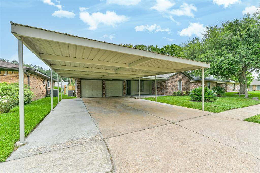 covered carport with driveway extensions