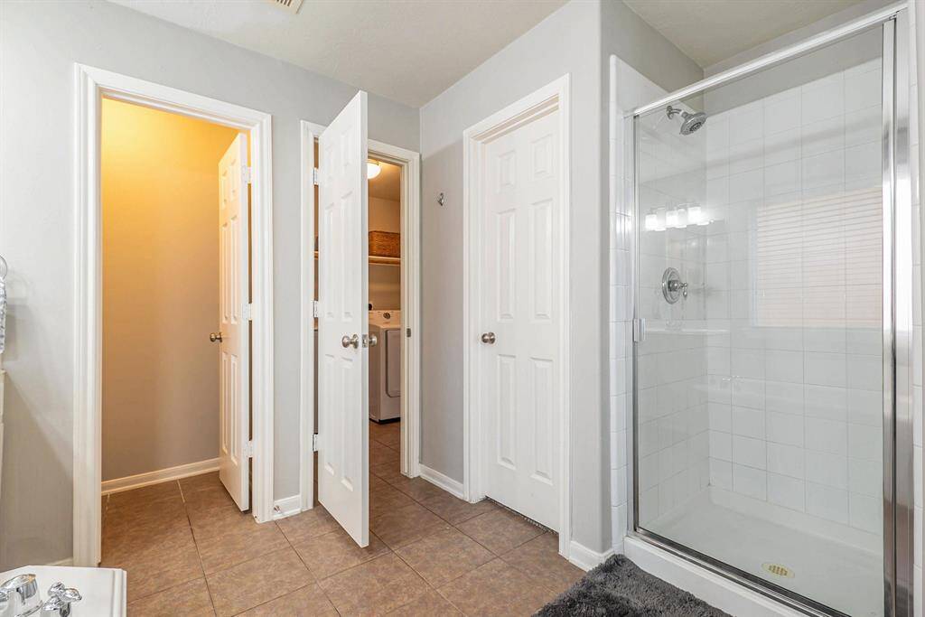 This primary bathroom also has dual walk-in closets and conveniently connects to the laundry room.