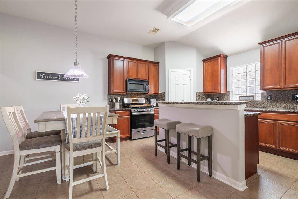 Chef's dream kitchen features a massive island, ample cabinet space, and breakfast bar seating.