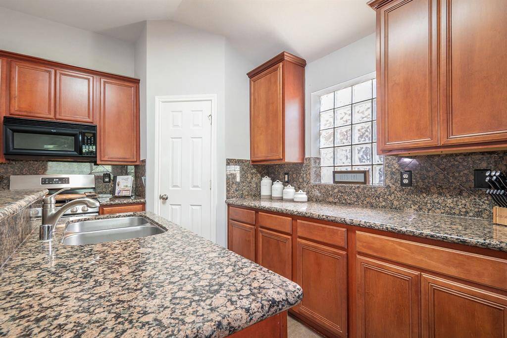 This fabulous kitchen also has beautiful countertops and a walk-in pantry!