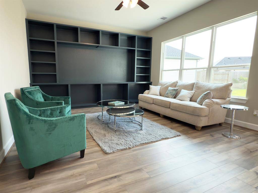 Step into the Portico's living room at Winfrey Estates, where elegance meets comfort in a beautifully designed space. Featuring expansive windows, luxurious finishes, and a warm, inviting atmosphere, this living room is the perfect place to relax, entertain, and create lasting memories. *Image depicts home as-is.