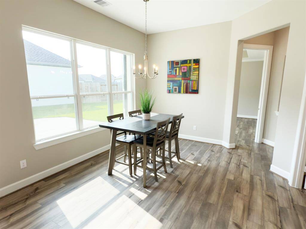 he dining room in the Portico at Winfrey Estates is an inviting, open space that seamlessly connects to the kitchen, perfect for both everyday meals and elegant entertaining. *Image depicts home as-is.