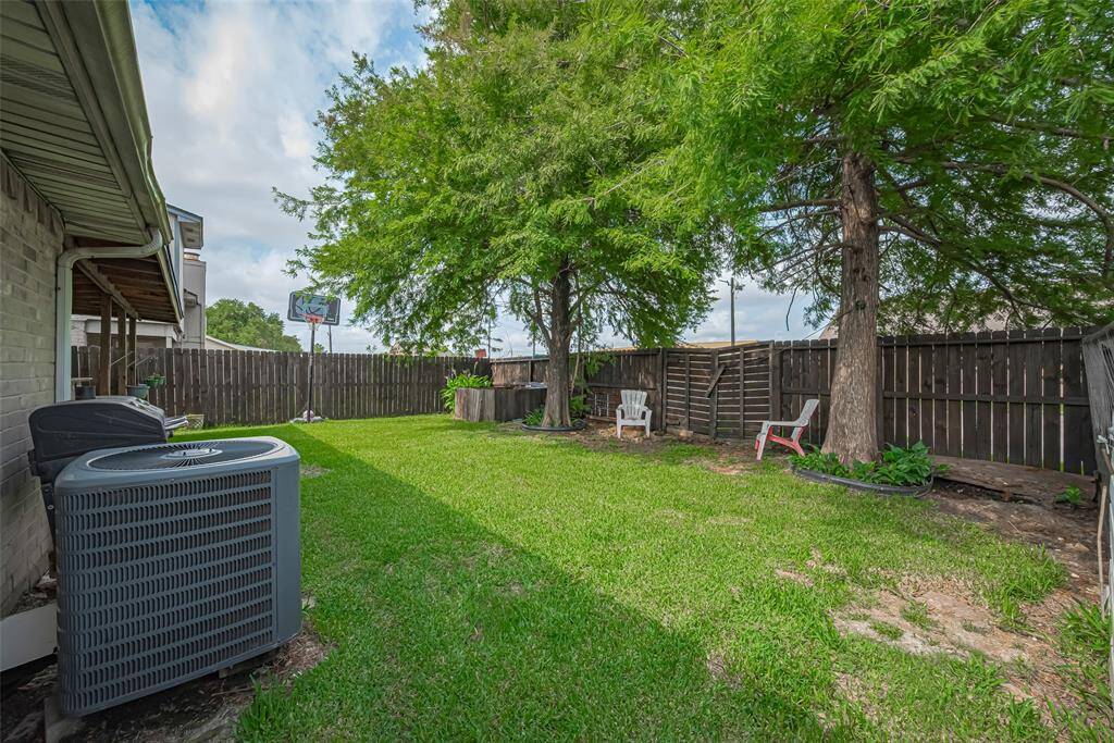 Spacious lawn with mature trees providing shade.
