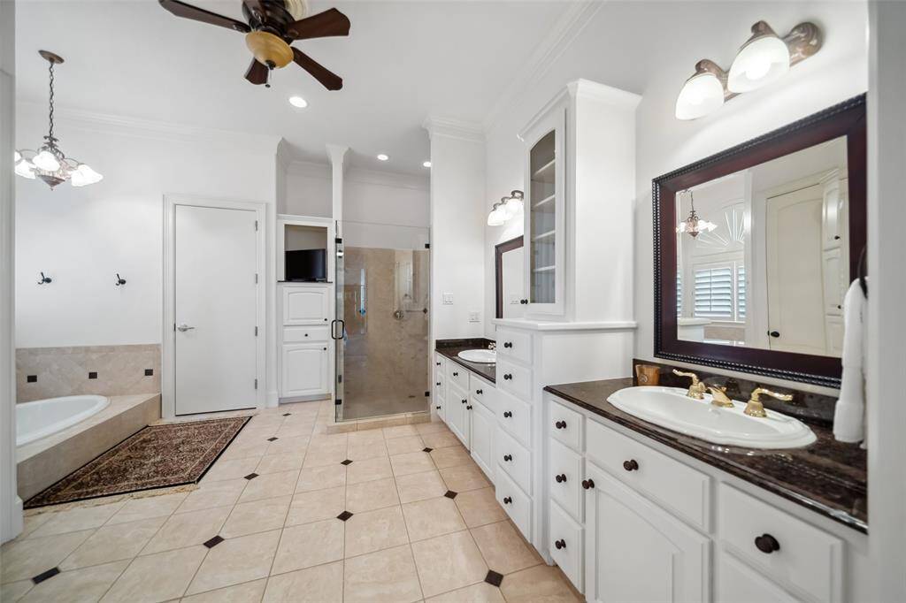 Primary Bath with dual sinks, tub with frameless shower.