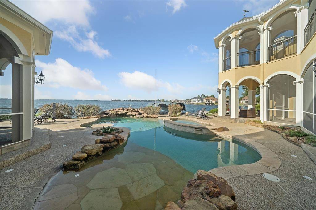 POOL is central with the home wrapped around it for the most amazing views from nearly every room. Features a beach entry for pets & cool sun lounging, spa, water-table with underwater seating & three scenic waterfalls..