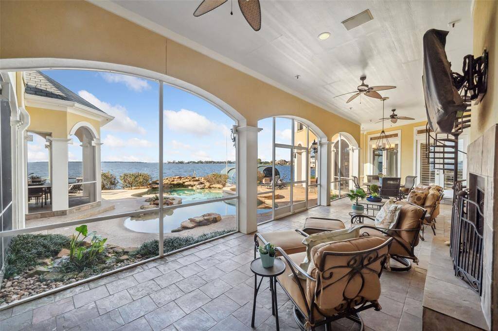 Huge screened porch with tv, fireplace, stairway access to the upper terrace & so many spaces to lounge & relax.