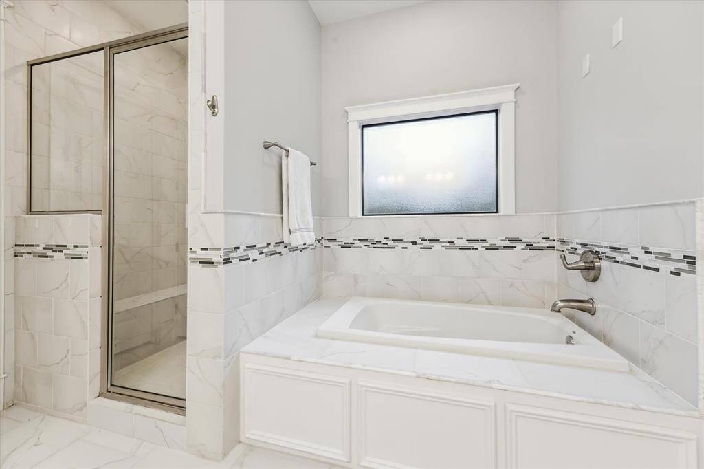 Whirlpool tub, separate shower, and generous space for daily routines.