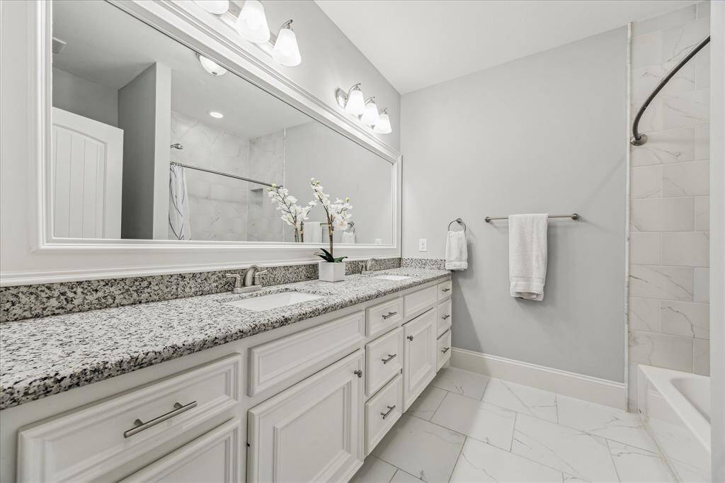 Hallway bath designed to serve the game room plus two bedrooms.
