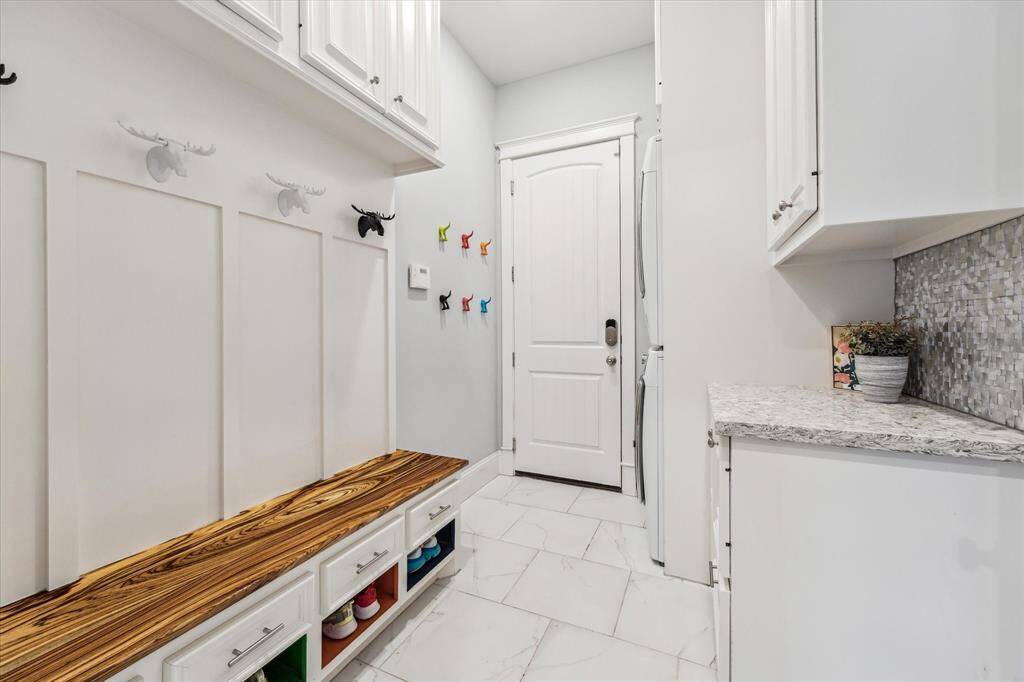 Garage entry leads to a practical mudroom and laundry room setup.