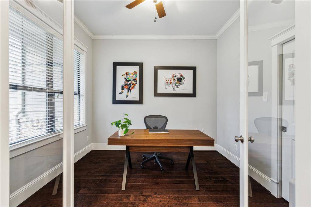 Home office featuring sleek glass doors that allow natural light to flow through.