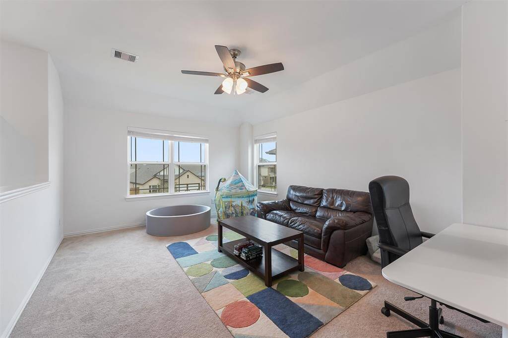 Spacious game room located at the top of the stairs