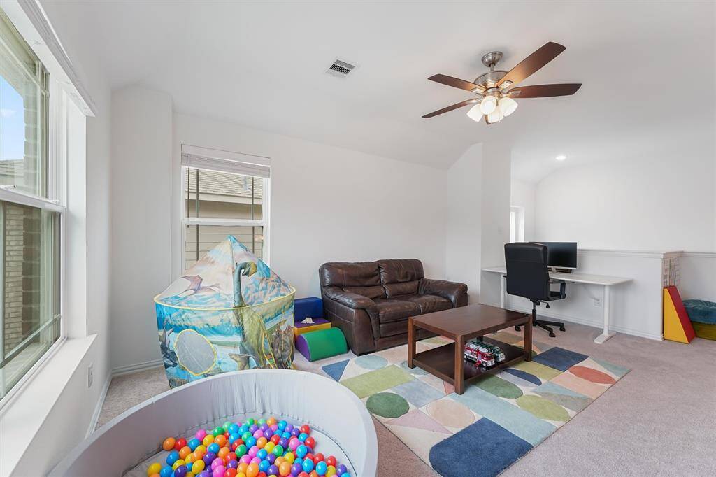 Spacious game room located at the top of the stairs