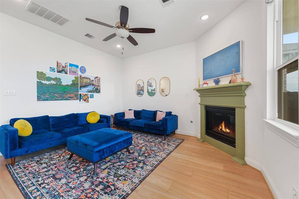 Family featuring a corner fireplace, large windows with views out to the covered patio