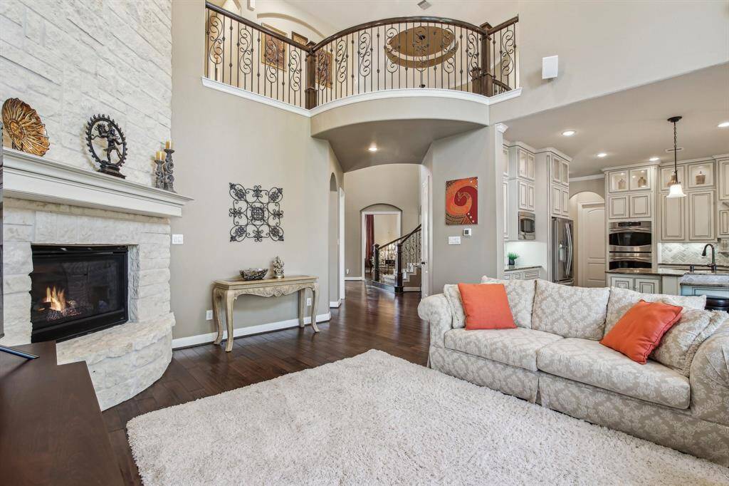 Expansive family room with a vaulted ceiling creates a bright, open atmosphere perfect for relaxing or entertaining. Generous wall space and natural light make it a comfortable and versatile gathering space.