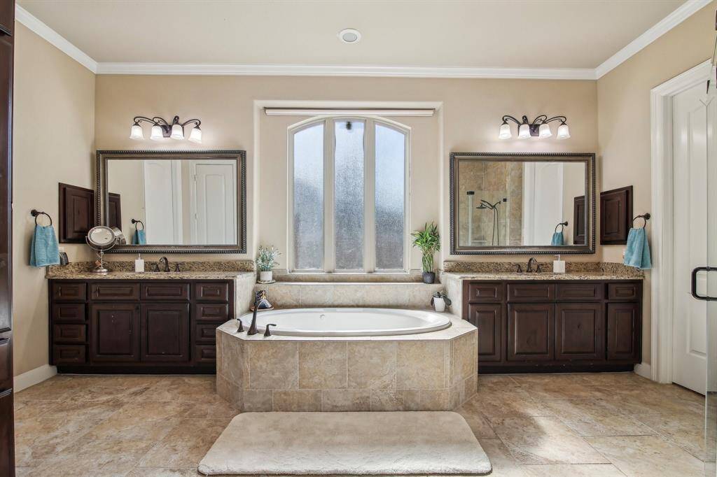 separate vanities for added convenience and a large soaking tub, creating a spa-like retreat to unwind and relax.