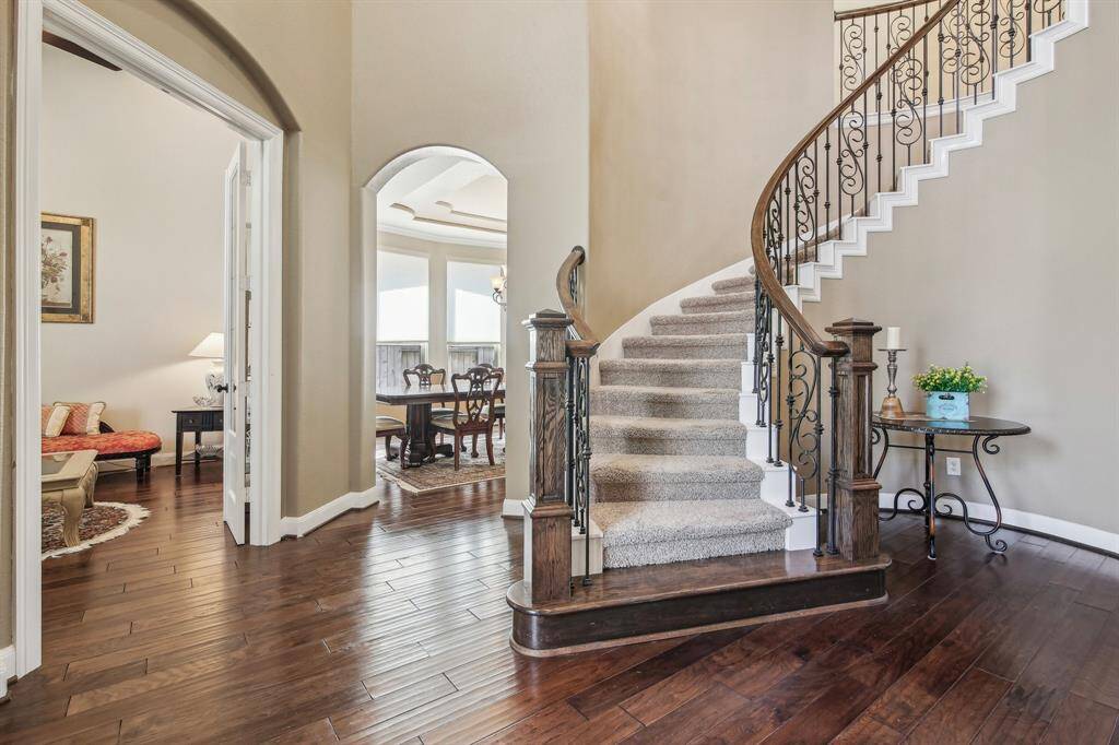 Stunning curved staircase greets you at the entry, setting the tone for timeless elegance.