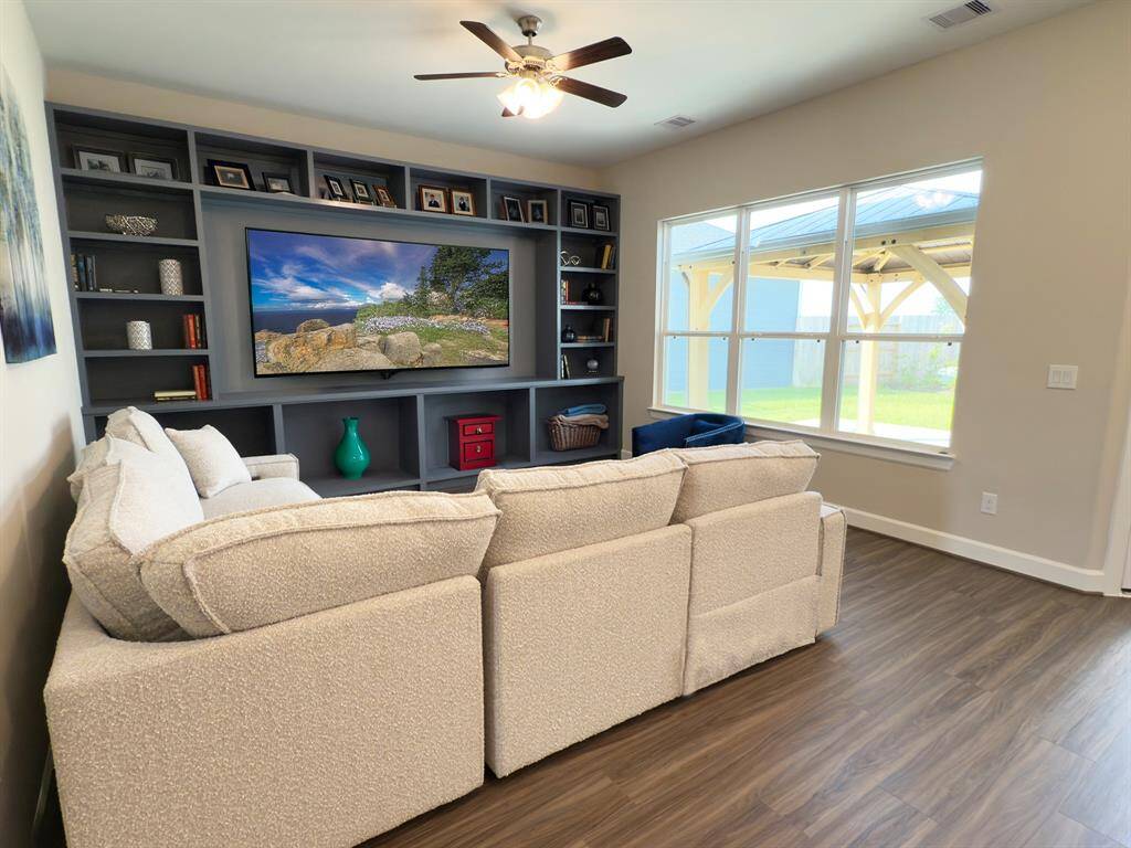 This living Space Features and expansive, light filled area with large windows and a versatile layout perfect for entertaining and everyday living. *Image depicts home as-is with some elements virtually staged.