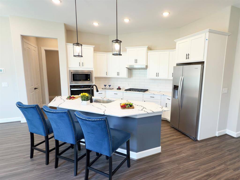 Indulge in elegance where the dining area seamlessly lends sophistication and comfort. With ample space, stunning finishes, and a warm ambiance, it provides intimate dinners and festive gatherings. *Image depicts home as-is.