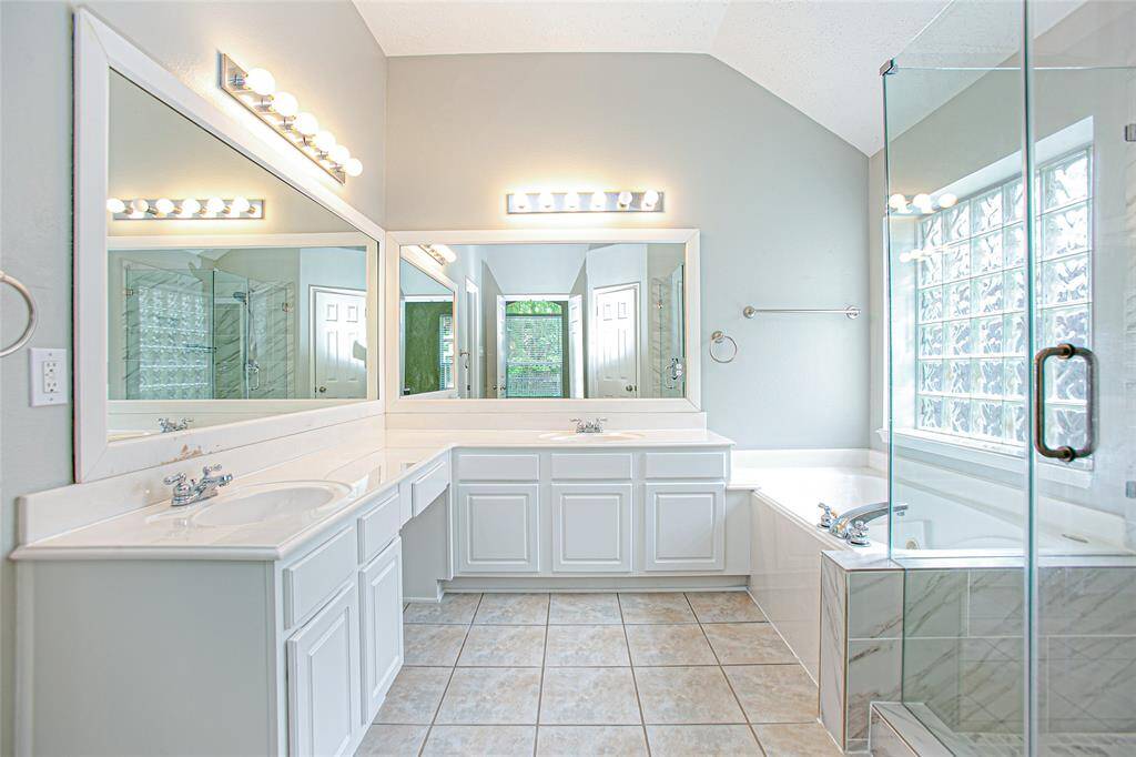 The master bath features a wrap-around vanity with dual sinks and an extra-large walk-in closet.