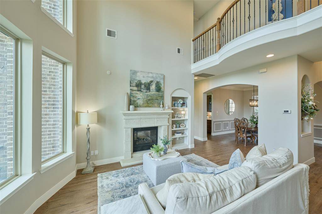 This elegant home boasts abundant natural light and a cozy fireplace, ideal for both relaxation and entertaining.
