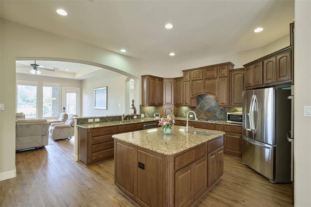 Discover a spacious kitchen with a central island, prep sink, and disposal. Enjoy the roomy walk-in pantry—ideal for cooking and entertaining.