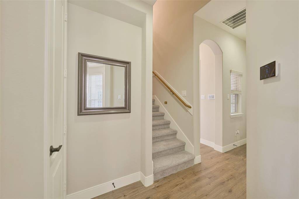 Bright breakfast nook with access to a sunlit back entry and second staircase.