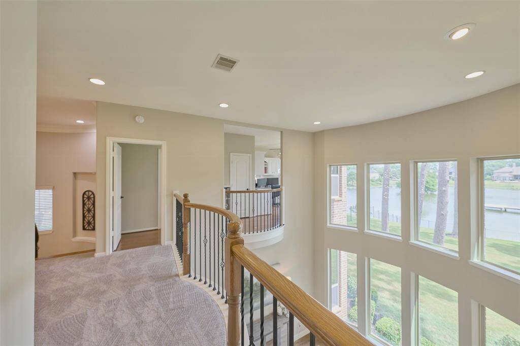 Discover a spacious, light-filled landing with elegant railings and stunning views. Perfect for relaxation or showcasing art, it seamlessly connects to bedrooms and living spaces.