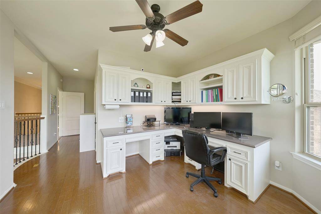 Bright and spacious upstairs office with custom cabinetry.