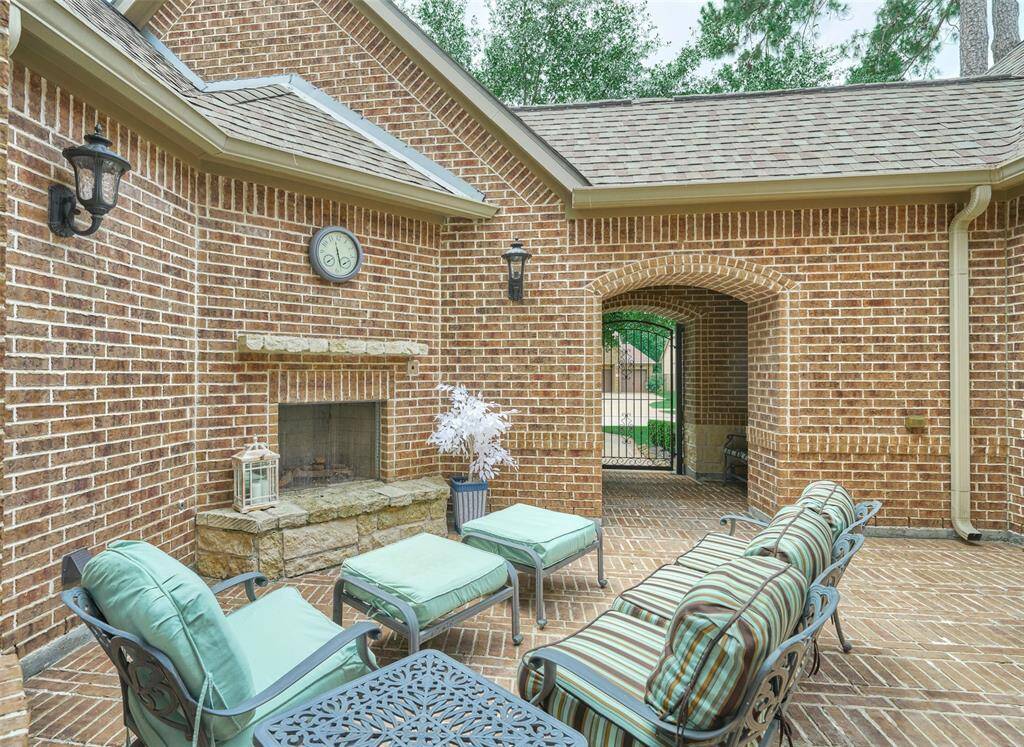 Delightful brick courtyard with a cozy outdoor fireplace, ideal for relaxation and entertaining.