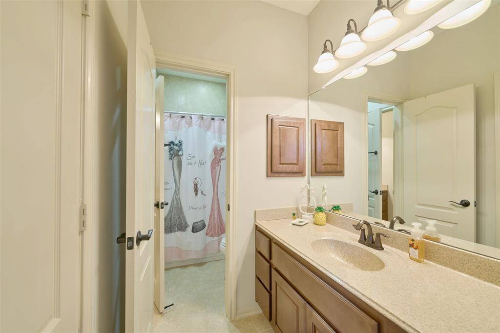 Elegant upstairs Jack and Jill bathroom with stylish fixtures and generous storage.