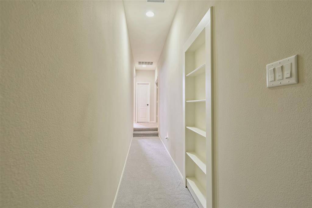 Explore a private hallway leading to a secluded control room, ideal for discreet convenience.