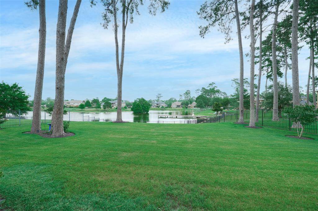 Spacious backyard with tranquil lake views, ideal for relaxation and outdoor fun.