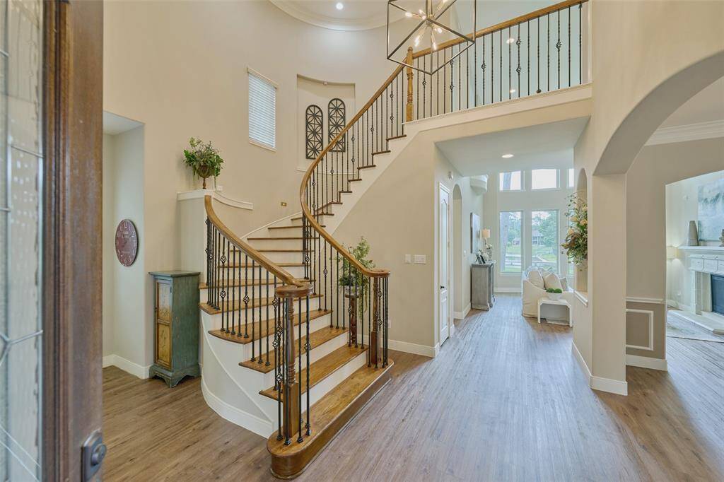 Step into elegance with a grand staircase, soaring ceilings, and abundant natural light, creating a stunning first impression.