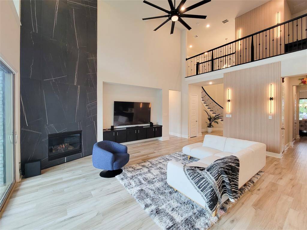 Another view. The sleek black tiled full-length modern fireplace & built-in with a spot for your T.V. & or entertainment center is the focal point of this Family room.
