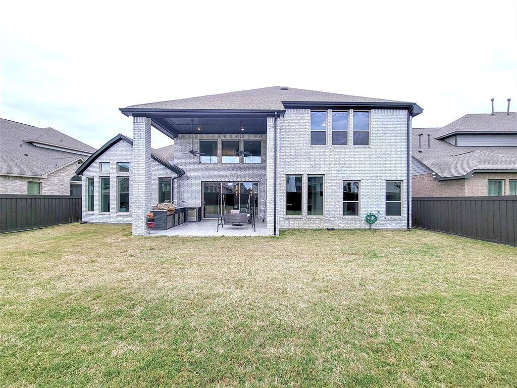 Backyard. Note the 2-story high ceiling covered patio with outdoor Kitchen. B-B-Q time!!