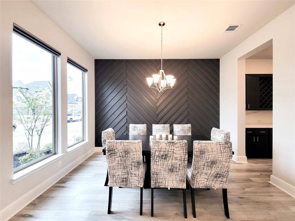 Formal Dining with striking dark wood paneled wall. All the windows have "Zebra" shades with remote controls. Ps: All window remote-control are also "Wi-Fi controlled" for convivence and ease.