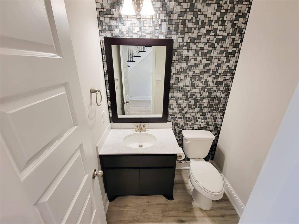 Pretty Guest Bathroom downstairs with tile accent wall.