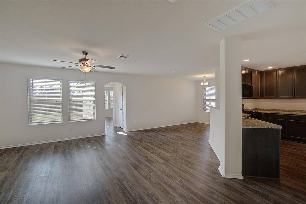 another view of the living room, and the kitchen to the right
