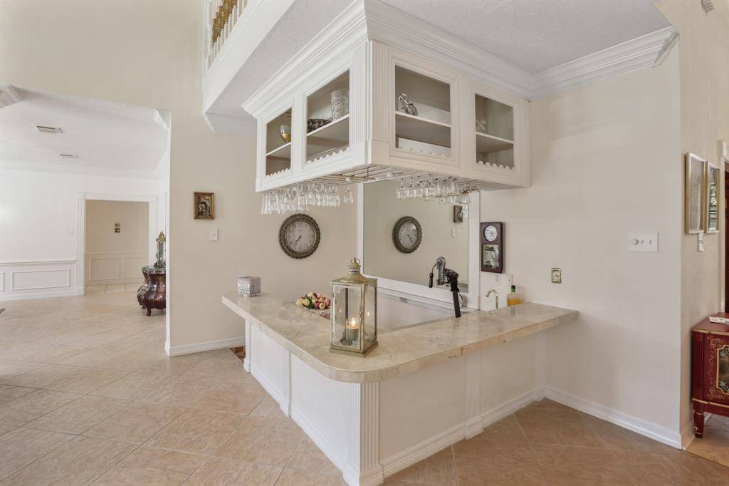 Owners had this bar custom made with granite counter top, sink with faucet and wall of mirrors.