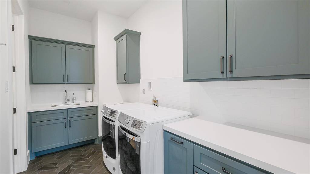 Laundry room with access to primary bedroom closet.