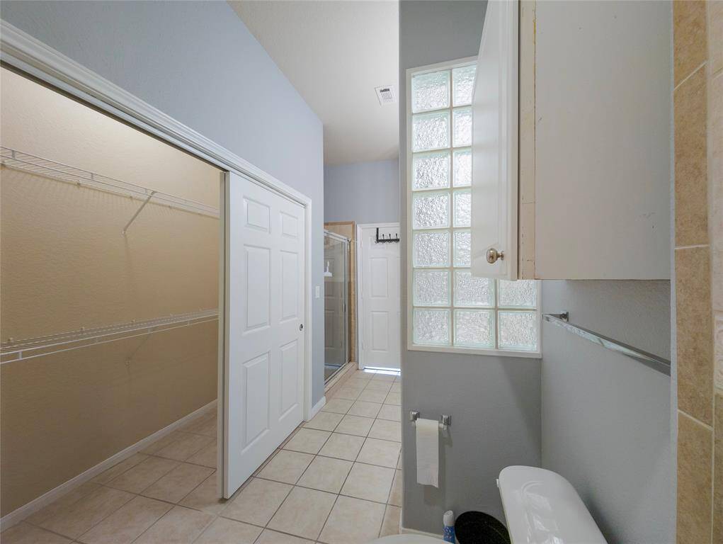 Primary bathroom with a walk-in closet