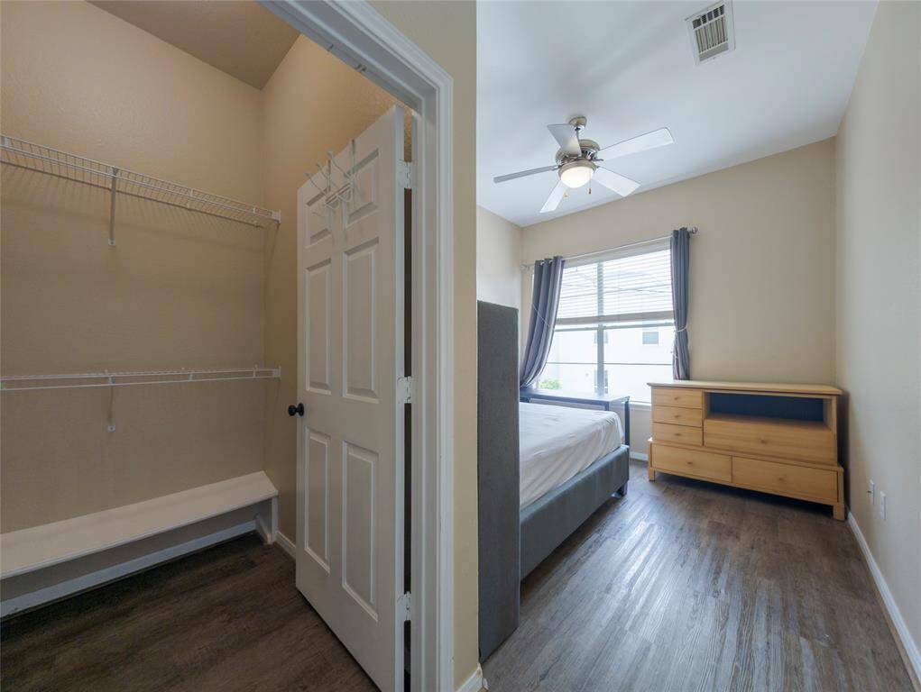 Secondary bedroom with a walk-in closet