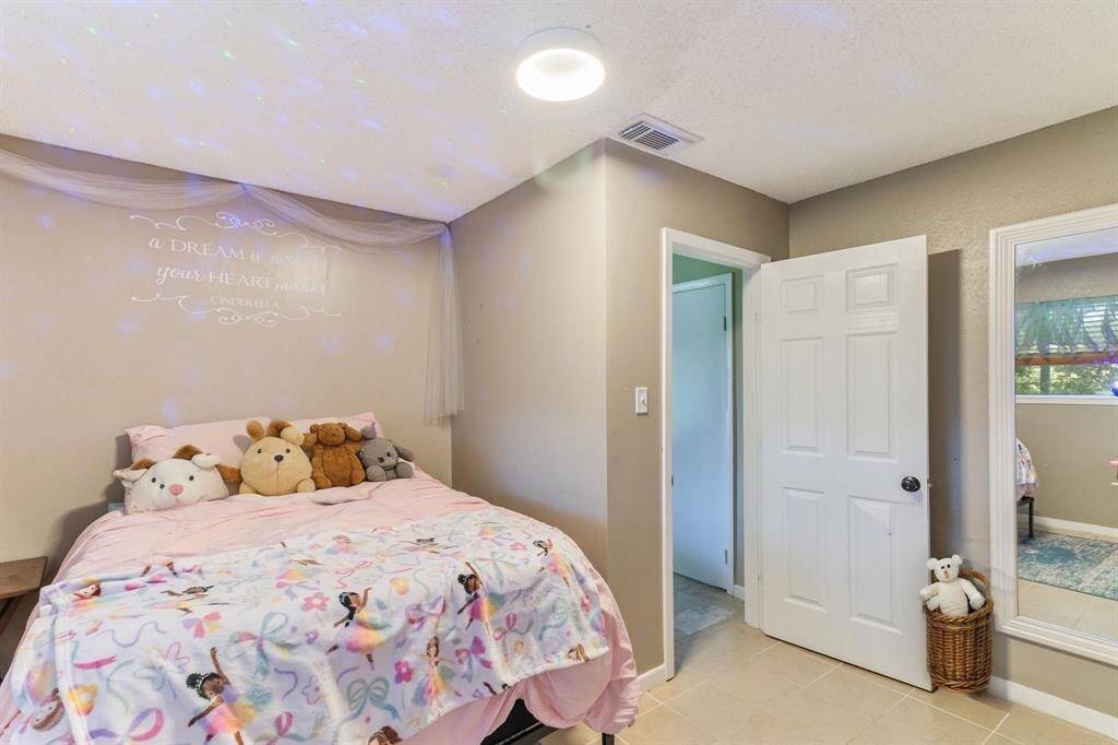Full secondary hallway bathroom offers a fresh coat of paint, a spacious vanity with neutral tile accents — making it a practical and stylish space for guests or family.