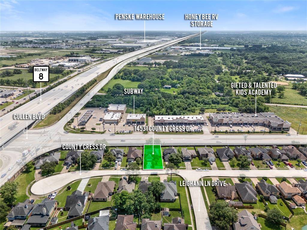 This aerial photo shows a residential area with a highlighted plot on County Cress Drive, near Beltway 8. Nearby amenities include a Subway restaurant and a kids' academy. The location offers convenient access to major roads and commercial facilities.