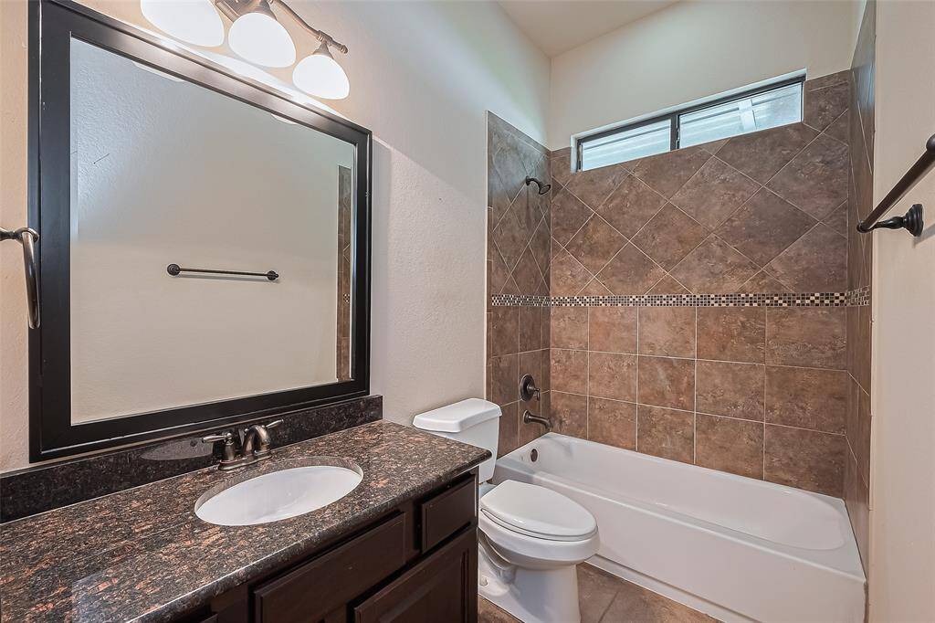 You will find granite countertops, Kohler sink, and Moen oil-rubbed bronze hardware in the downstairs bathroom. Tub/shower is surrounded with 12x12 diagonal pattern ceramic tile ribbon detail.