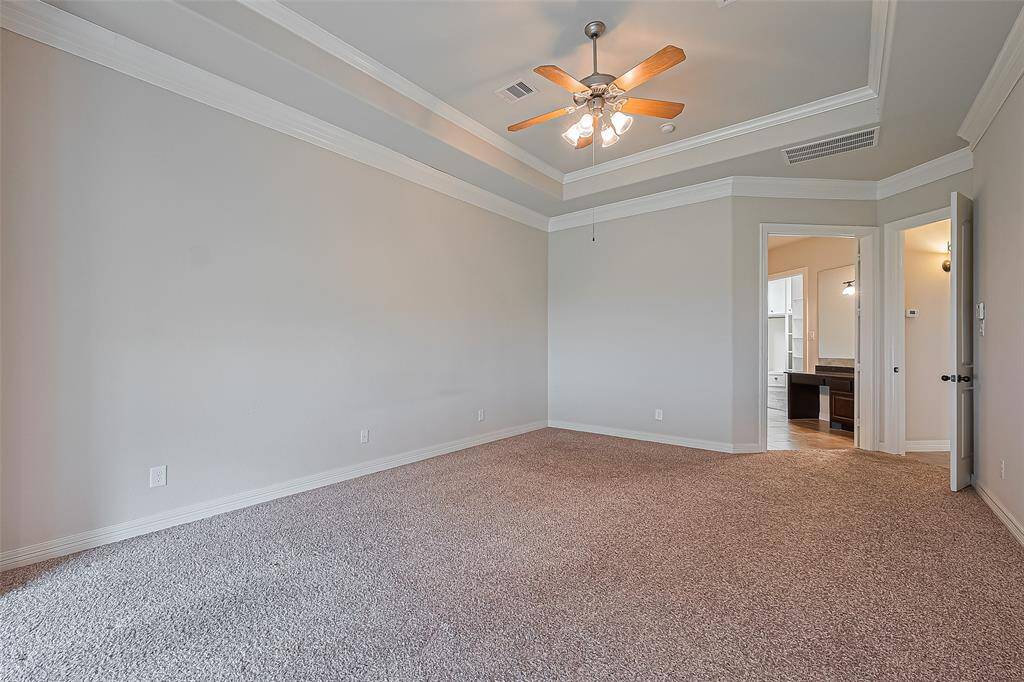 The divine, 25x14 master bedroom presents an 11 foot tiered ceiling with double crown molding and ceiling fan with light kit. Frieze carpet throughout this spacious and luxurious room.