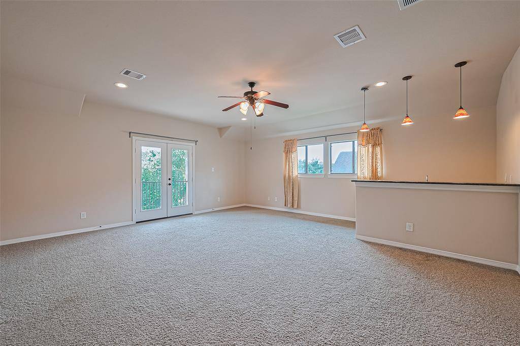The 21x20 game room has a custom feature wet bar with granite counter and a raised bar overhang. The 6 foot French door lead to a covered balcony overlooking the front of the home.