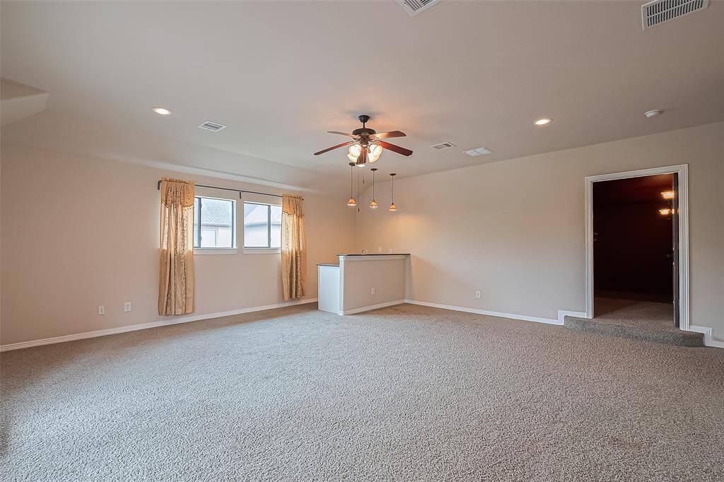 The game room also has ceiling fan with light kit, carpet and recessed lighting. Door leads to the media room.