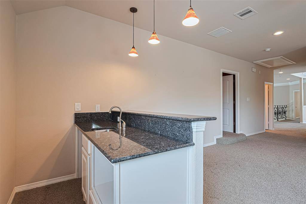 The wet bar has a cut out for microwave and beverage center.