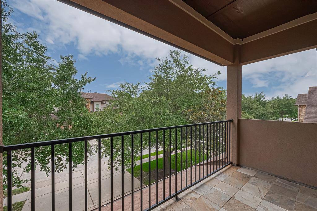 Covered balcony off of the game room overlooking the front yard.